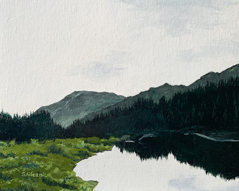Original 8x10 oil painting of a moody landscape with a light sky, still lake, dark pine reflections, distant hills, and a grassy meadow.