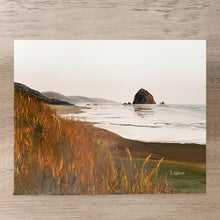 Load image into Gallery viewer, Original oil painting of Cannon Beach at sunset, featuring soft pastel skies, silhouetted sea stacks, and gentle waves reflecting warm hues.

